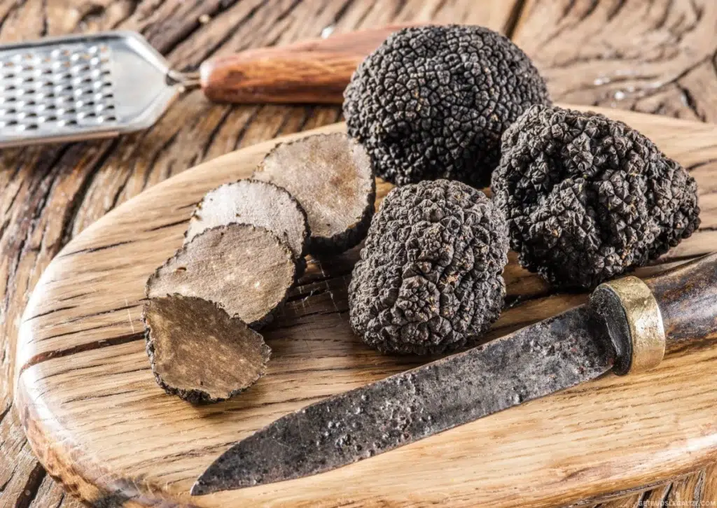How to Get High Naturally: 9 Drug-Free Ways to Boost Your Mood 13 Finely sliced black truffles on pasta with dark chocolate pieces on a wooden table, showcasing natural mood-boosting foods.