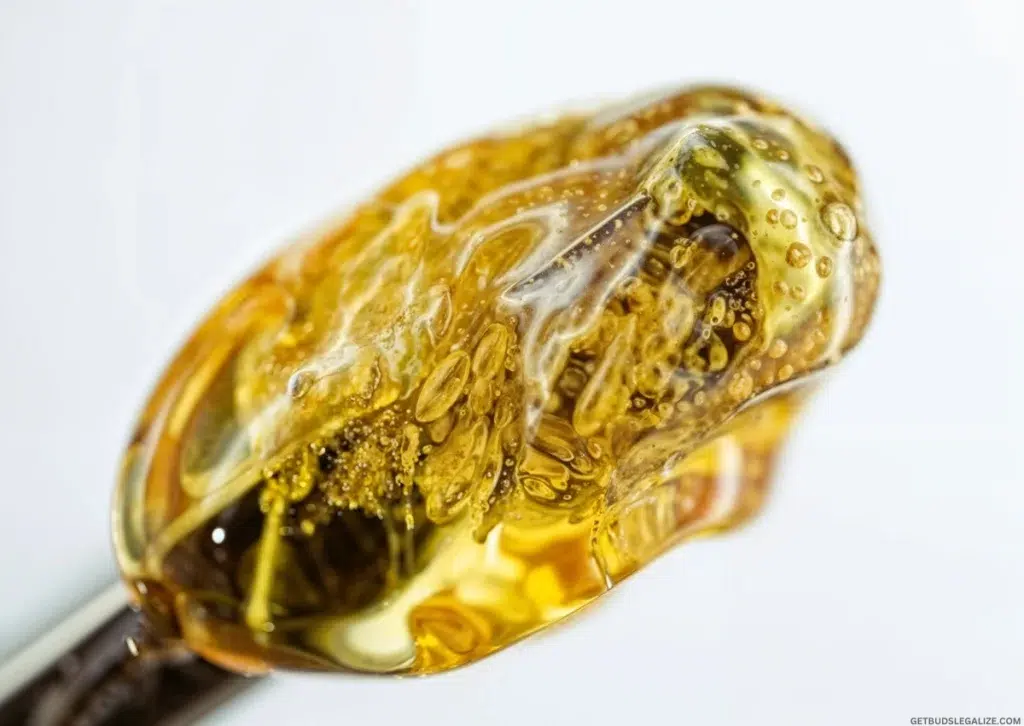 How to Make Cannabis Distillate at Home (Step-by-Step Guide) 11 How to Make Cannabis Distillate at Home — a golden sample of cannabis distillate on a metal tool, highlighting its clarity and thick, syrup-like consistency.