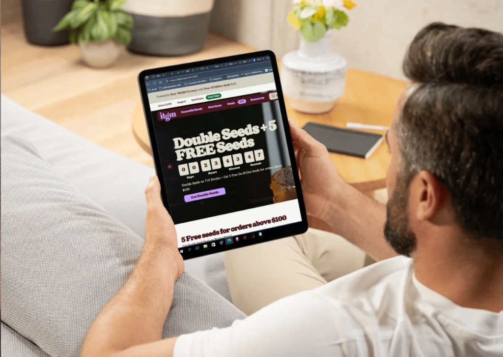 ILoveGrowingMarijuana Review: Honest Insight Before You Buy Seeds 7 Person sitting on a couch browsing the ILGM website on a tablet, ready to buy cannabis seeds.